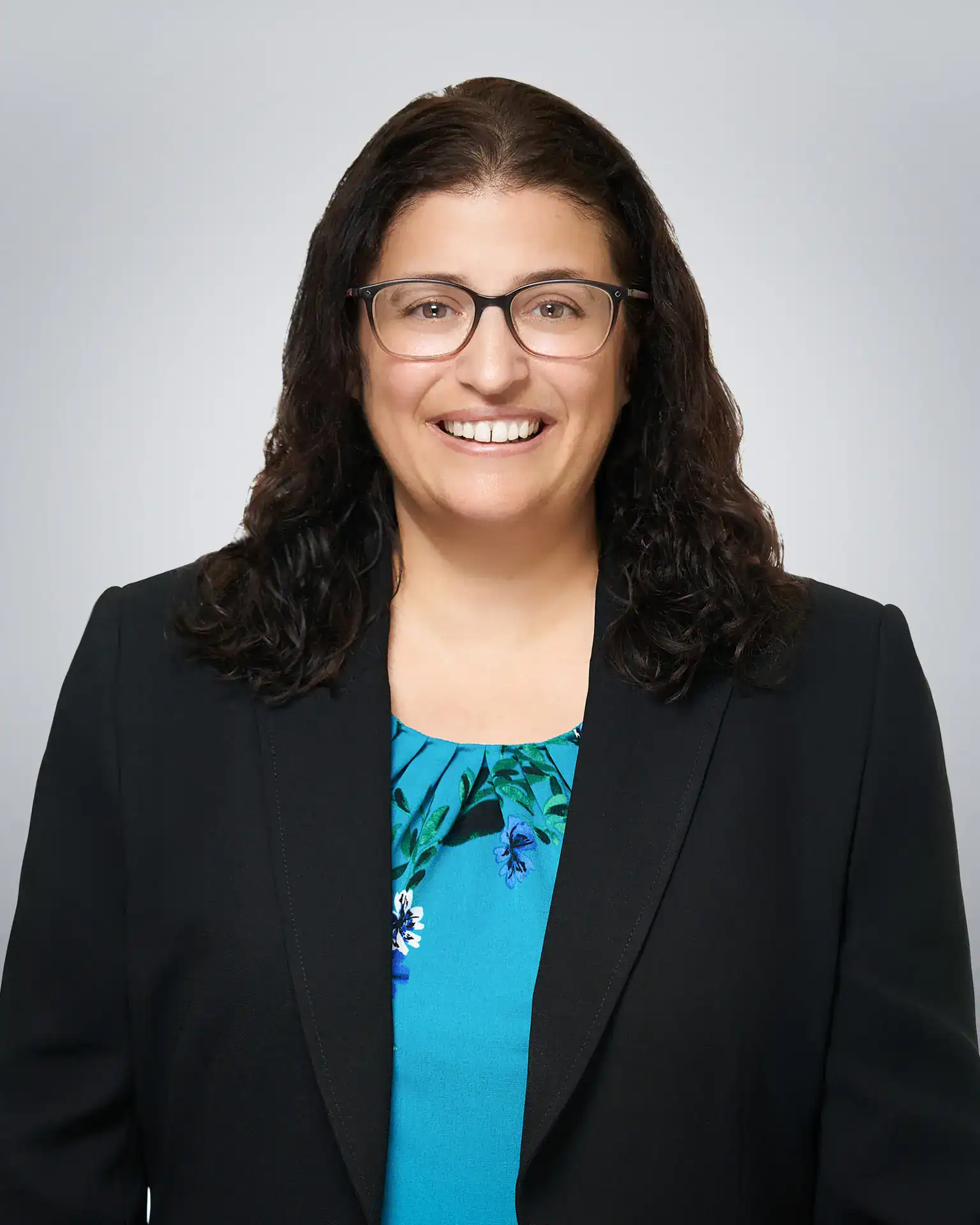 Attorney Doll Amir Eley smiling in professional portrait.