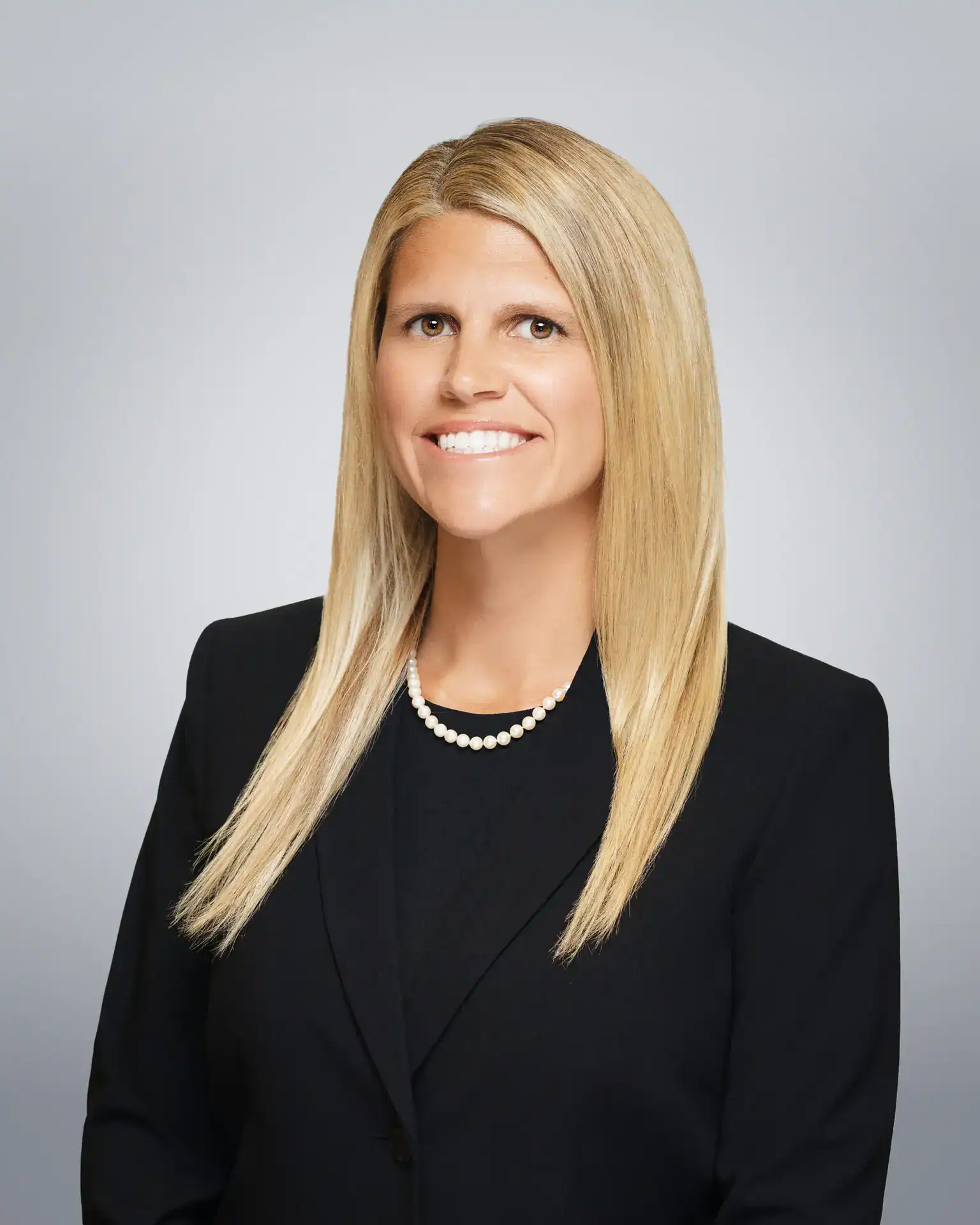 Attorney Doll Amir Eley smiling in professional attire.