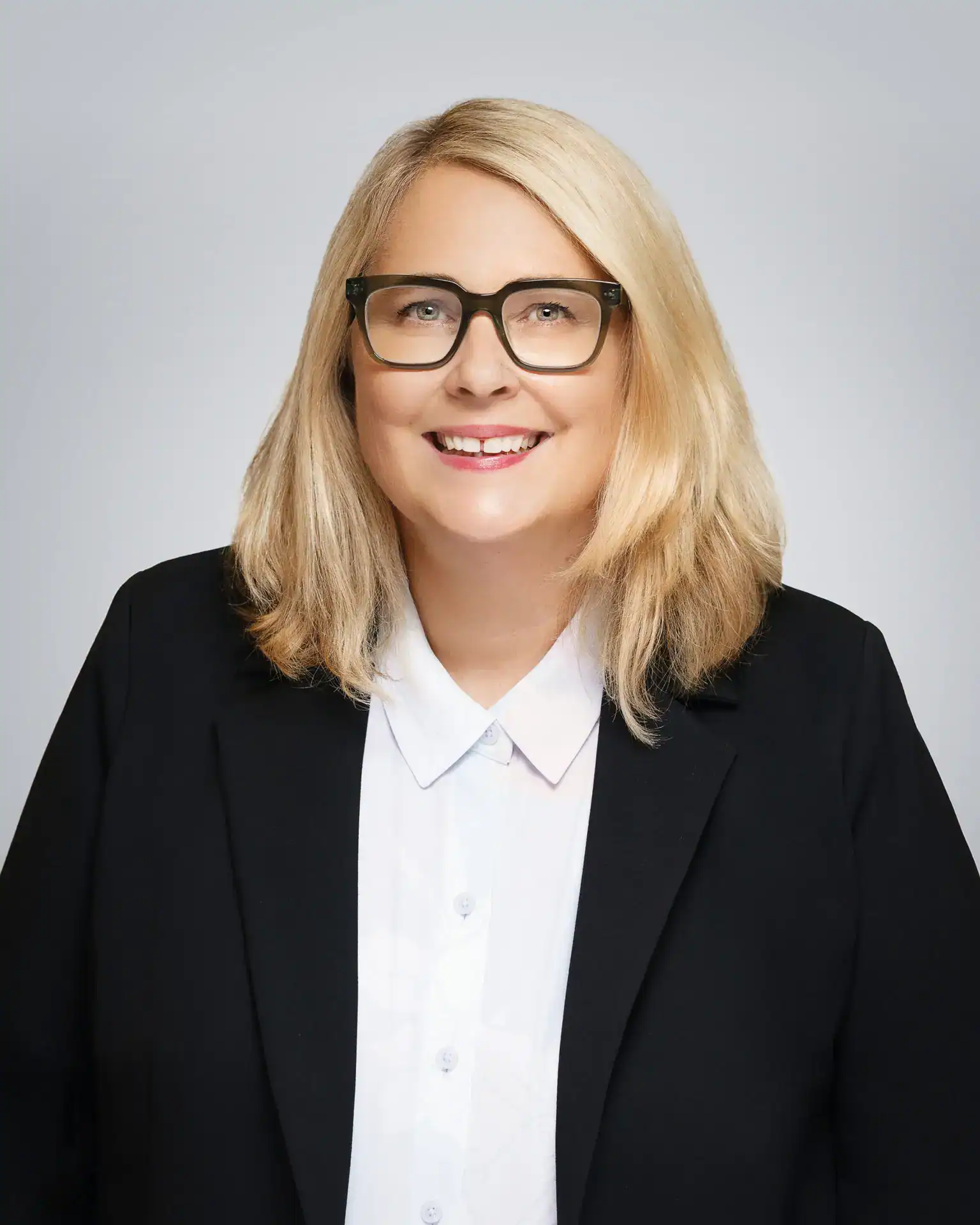 Attorney Doll Amir Eley smiling in professional attire.