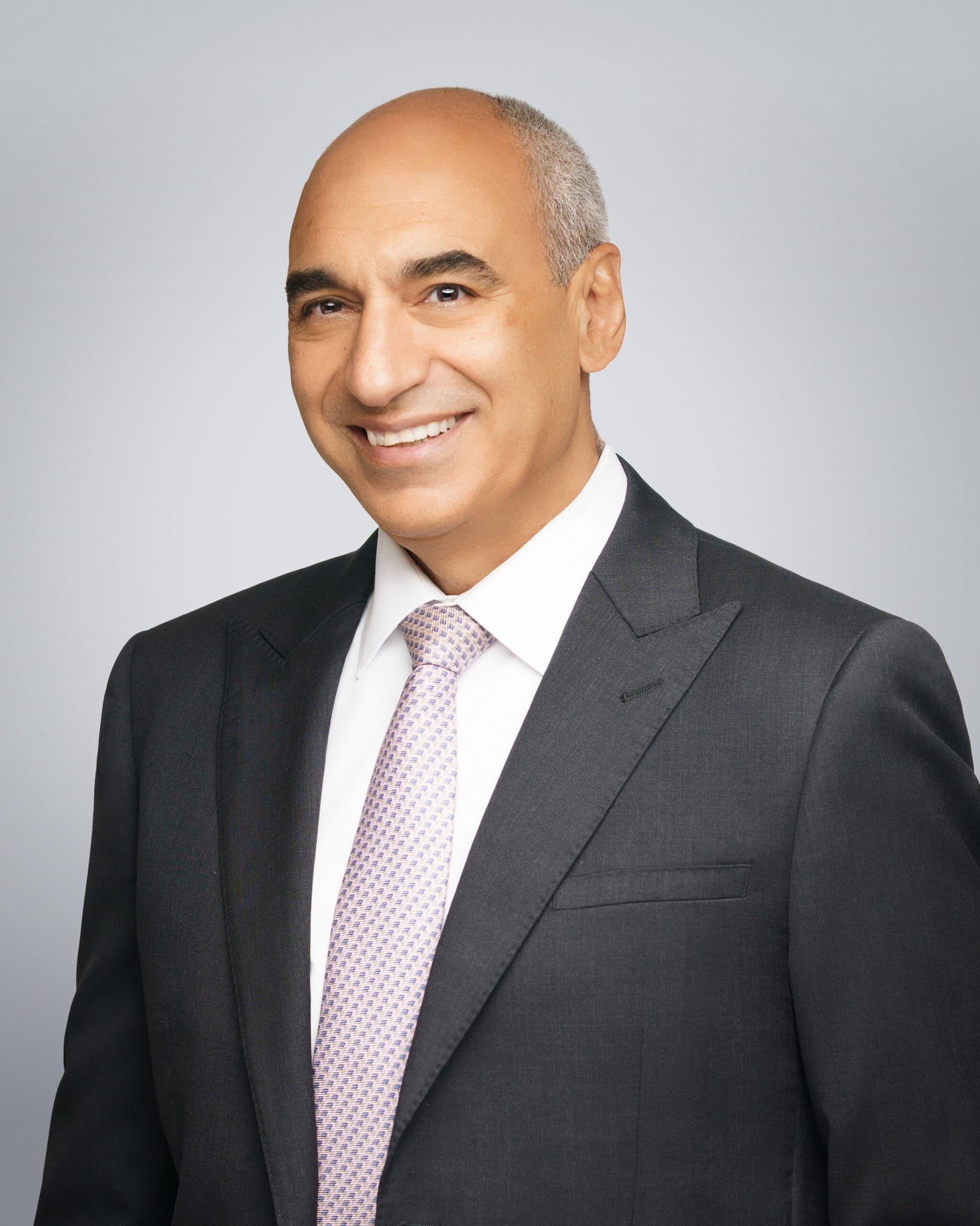 Professional portrait of Michael M. Amir, attorney at law, smiling in a suit.